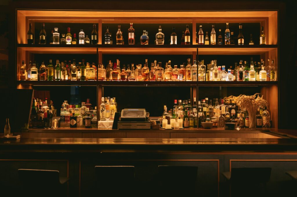 bar interior with shelves of spirits and cocktails