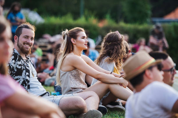 festival crowd sitting on lawns at outdoor event