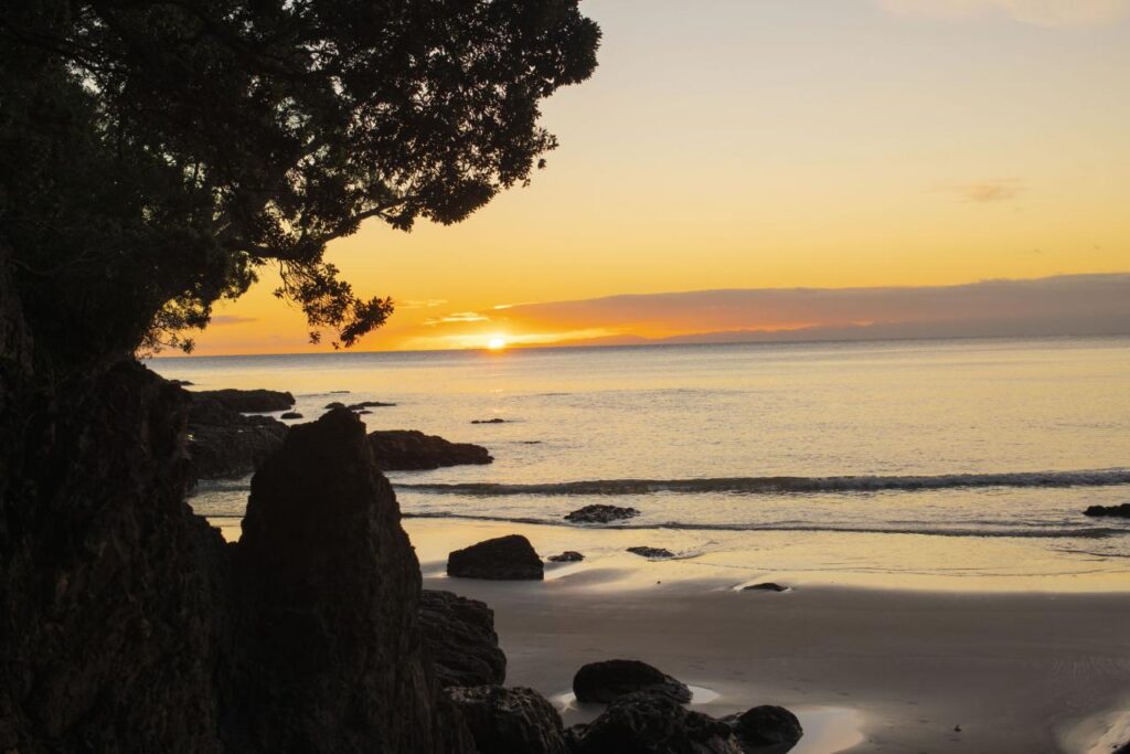 sunset over sandy beach with orange sky